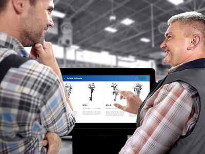 two men using a kiosk with boat motors on the screen